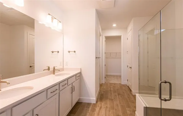 a spacious bathroom with a shower and a sink