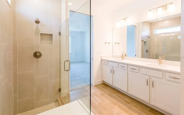 a spacious bathroom with a shower and a sink