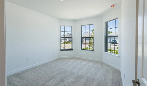 a view of an empty room with windows