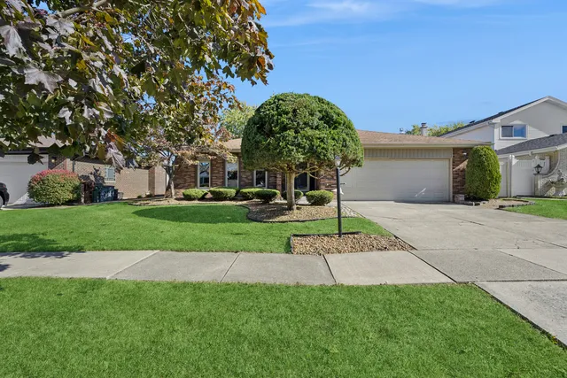 a kitchen with stainless steel appliances granite countertop a refrigerator a sink dishwasher a dining table and chairs with wooden floor