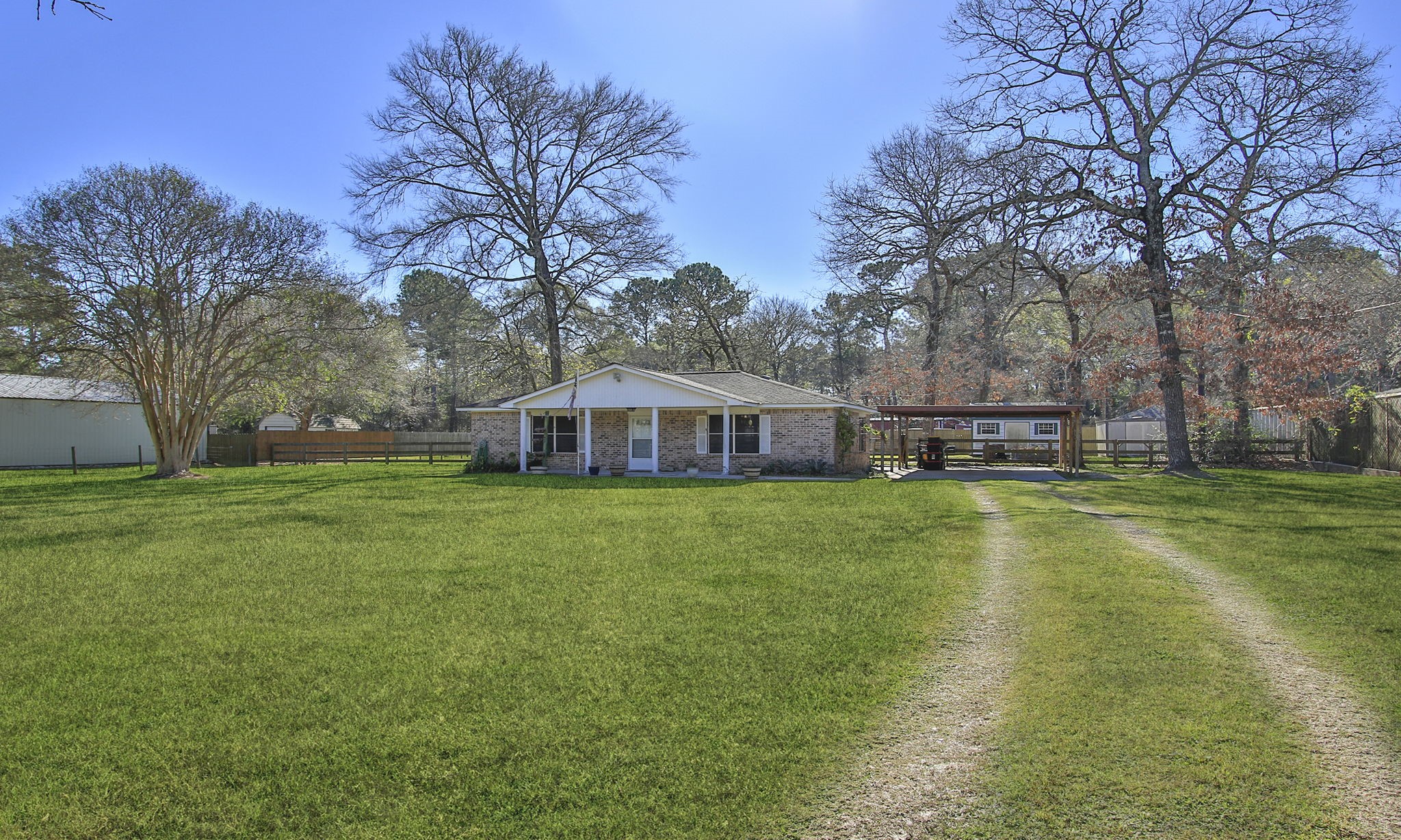 Charming single-story home with a welcoming front porch, set on .87 acres in the community of Clear Creek Forest.  Features mature trees and a long driveway, providing a serene and private setting. Ideal for those seeking a cozy residence with ample outdoor space.