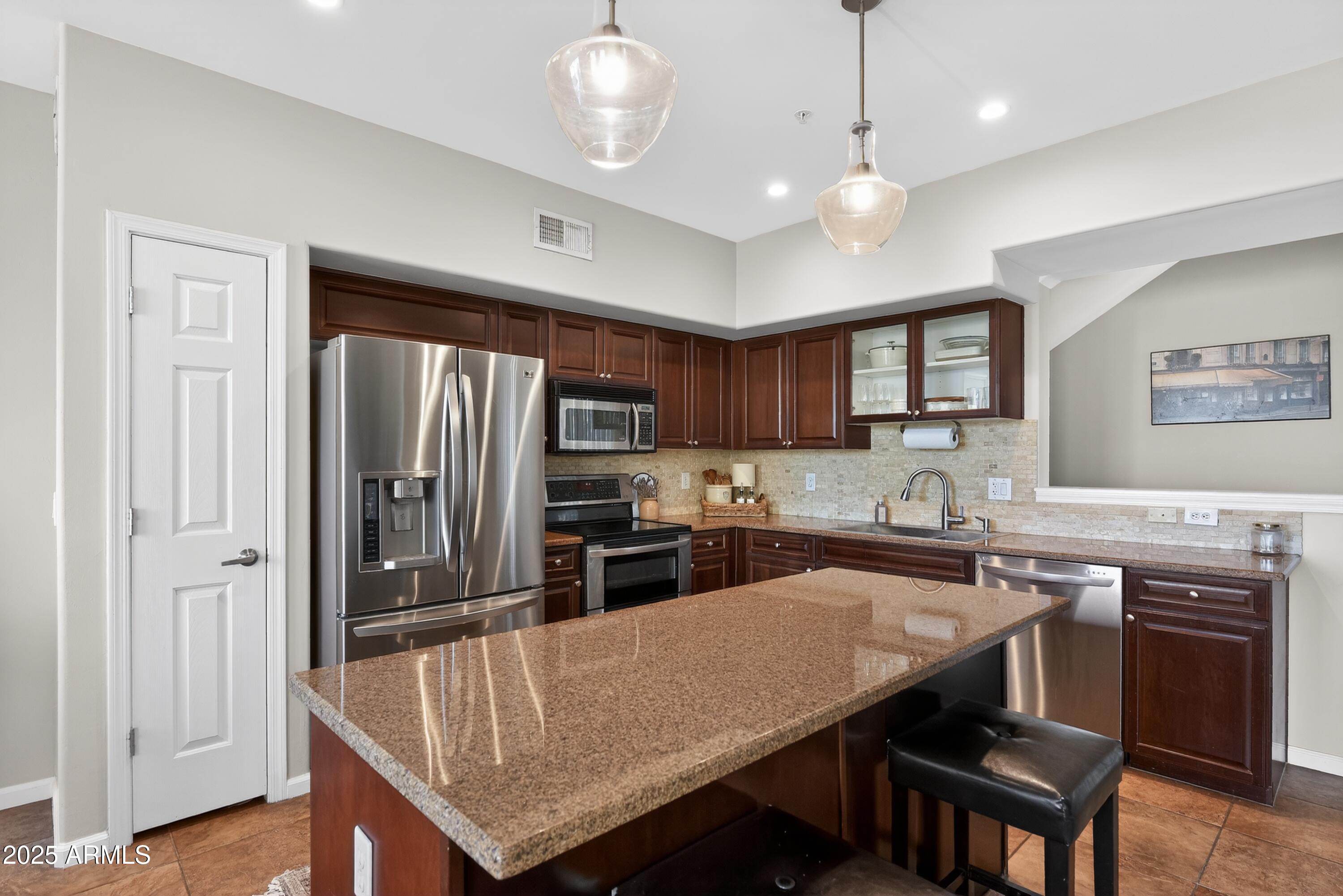 1920 East Bell Road, Unit 1079 Phoenix, AZ 85022 - Photo 12 of 29 a kitchen with a stove a refrigerator and a sink
