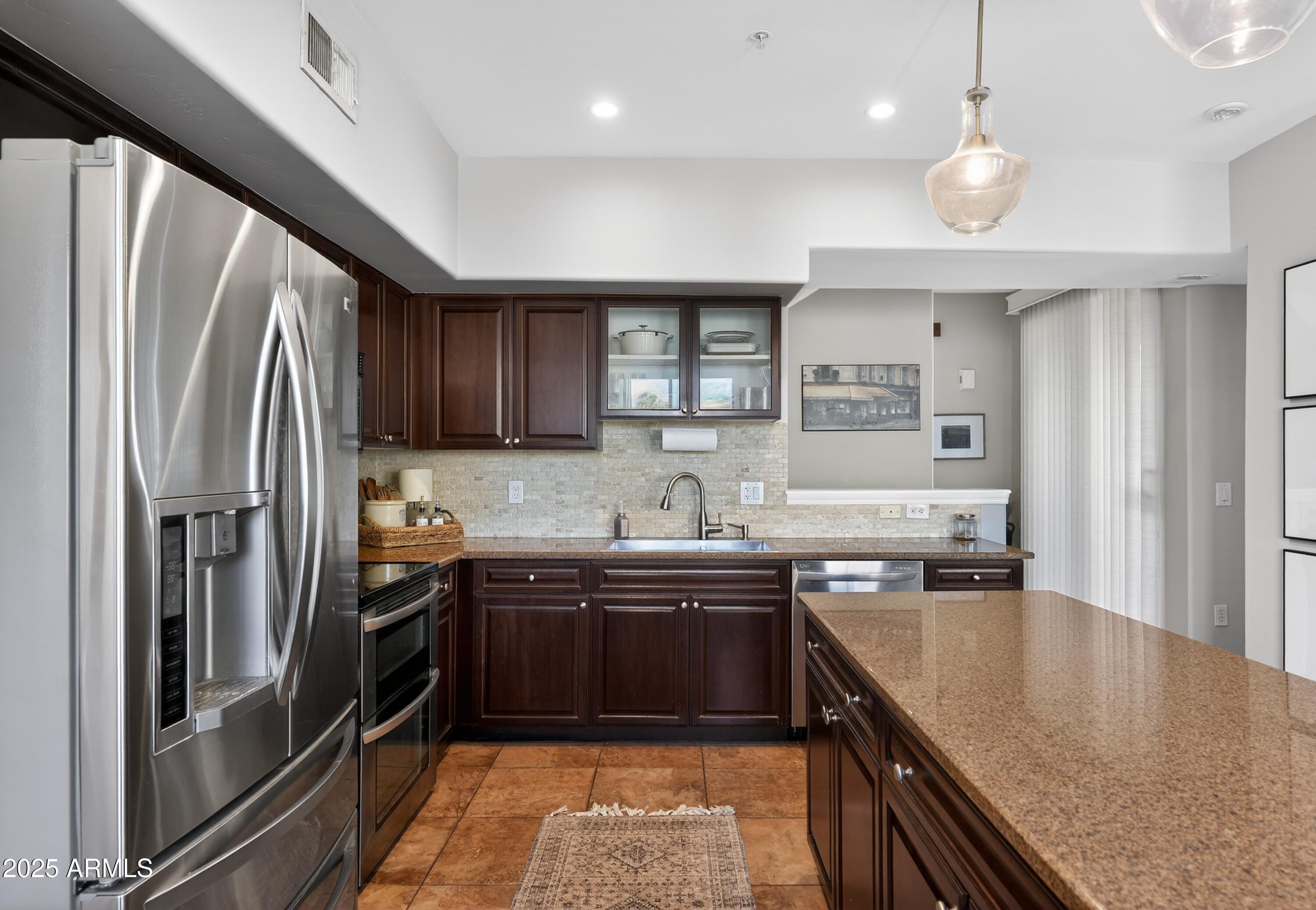 1920 East Bell Road, Unit 1079 Phoenix, AZ 85022 - Photo 14 of 29 a kitchen with stainless steel appliances granite countertop sink stove refrigerator and cabinets