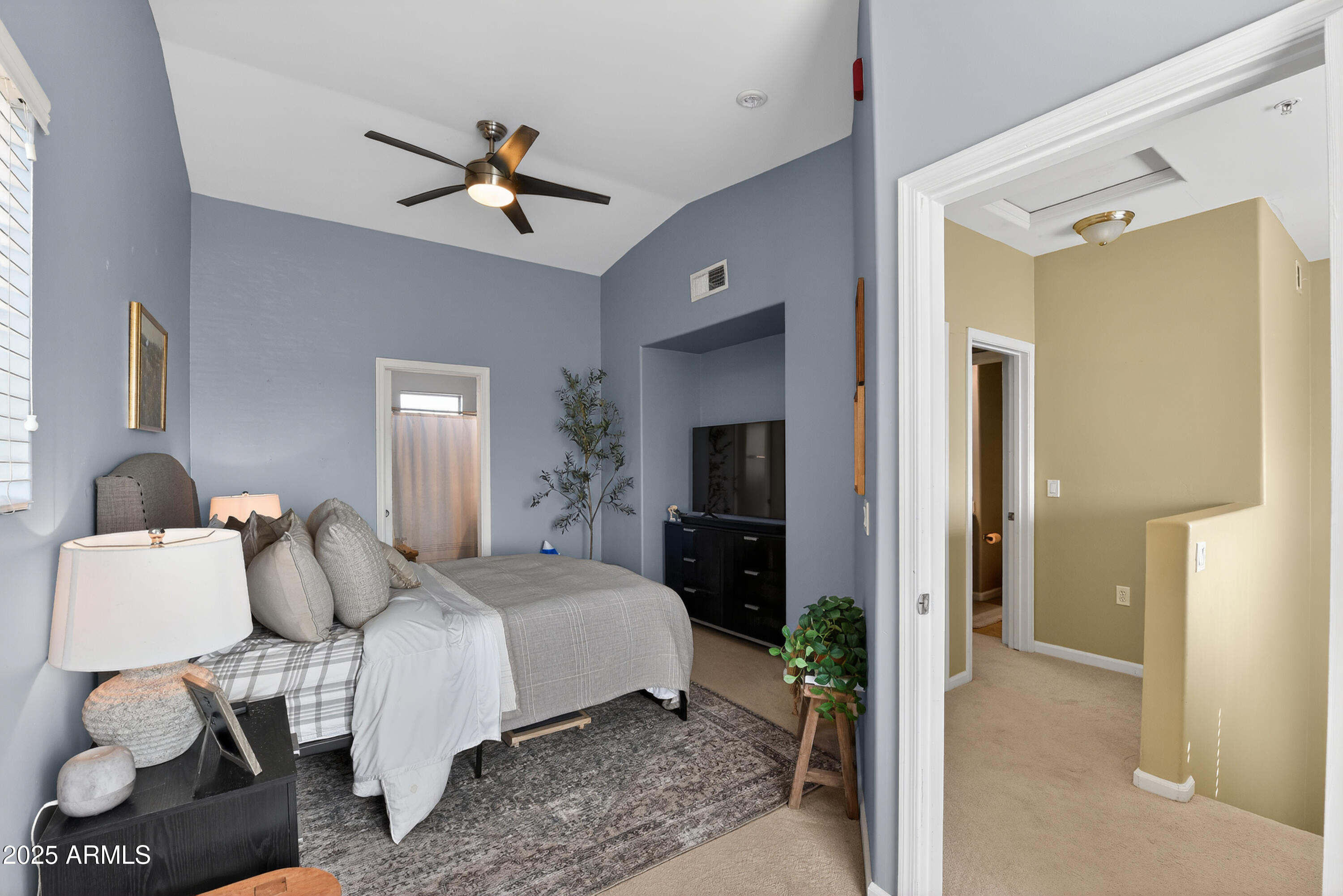 1920 East Bell Road, Unit 1079 Phoenix, AZ 85022 - Photo 22 of 29 a bedroom with a bed and a chandelier