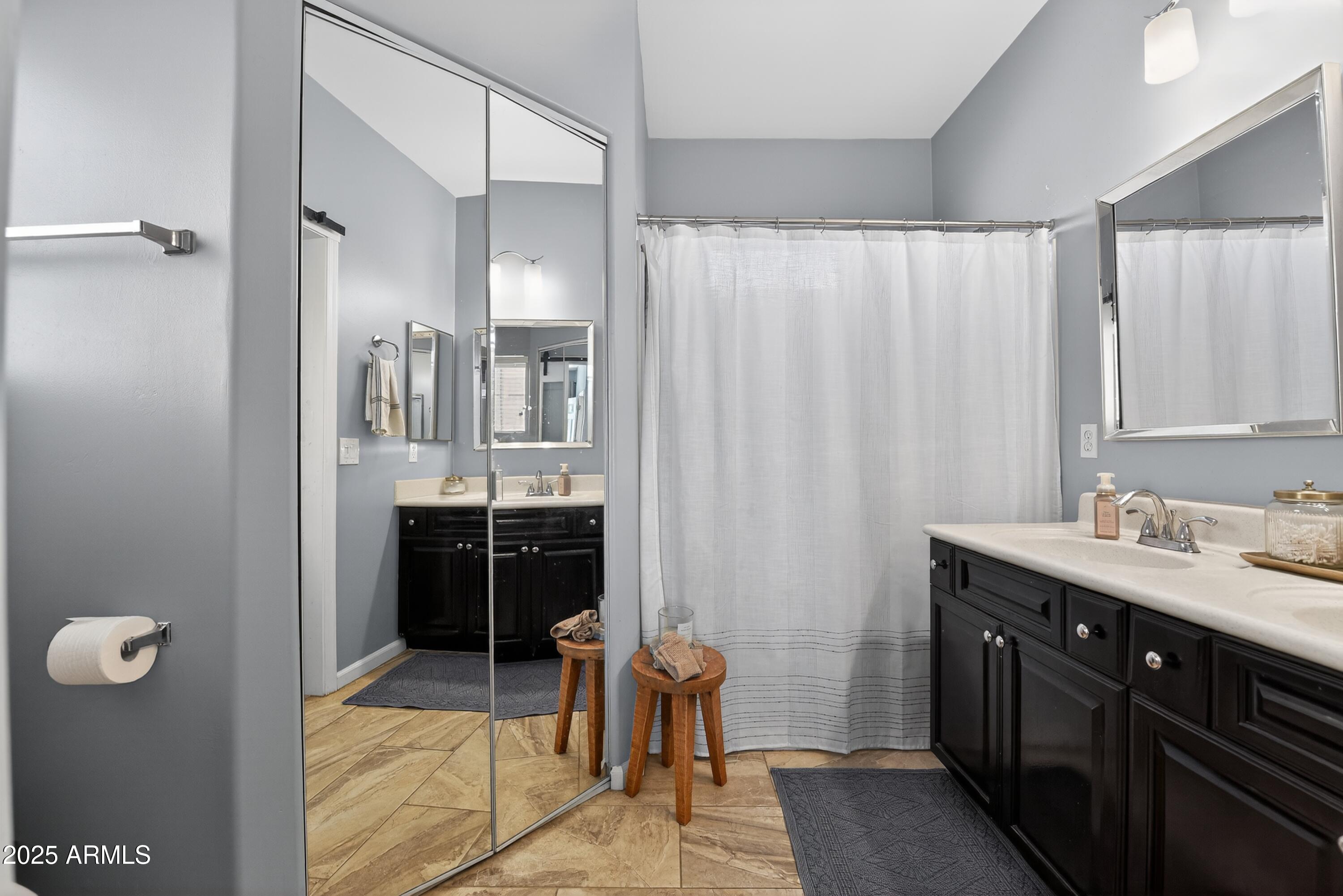 1920 East Bell Road, Unit 1079 Phoenix, AZ 85022 - Photo 23 of 29 a spacious bathroom with a double vanity sink a mirror and a shower