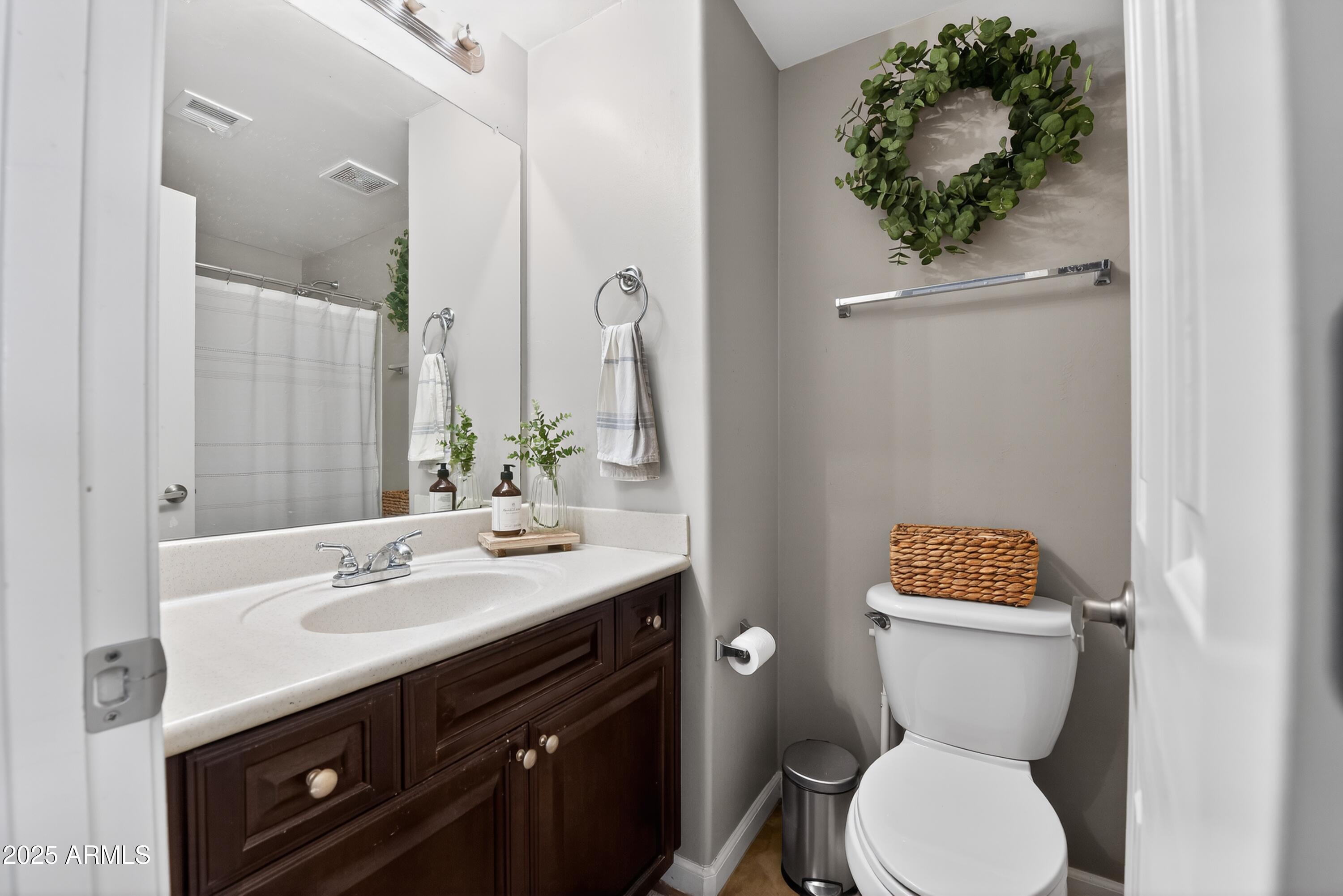 1920 East Bell Road, Unit 1079 Phoenix, AZ 85022 - Photo 26 of 29 a bathroom with a toilet sink and mirror