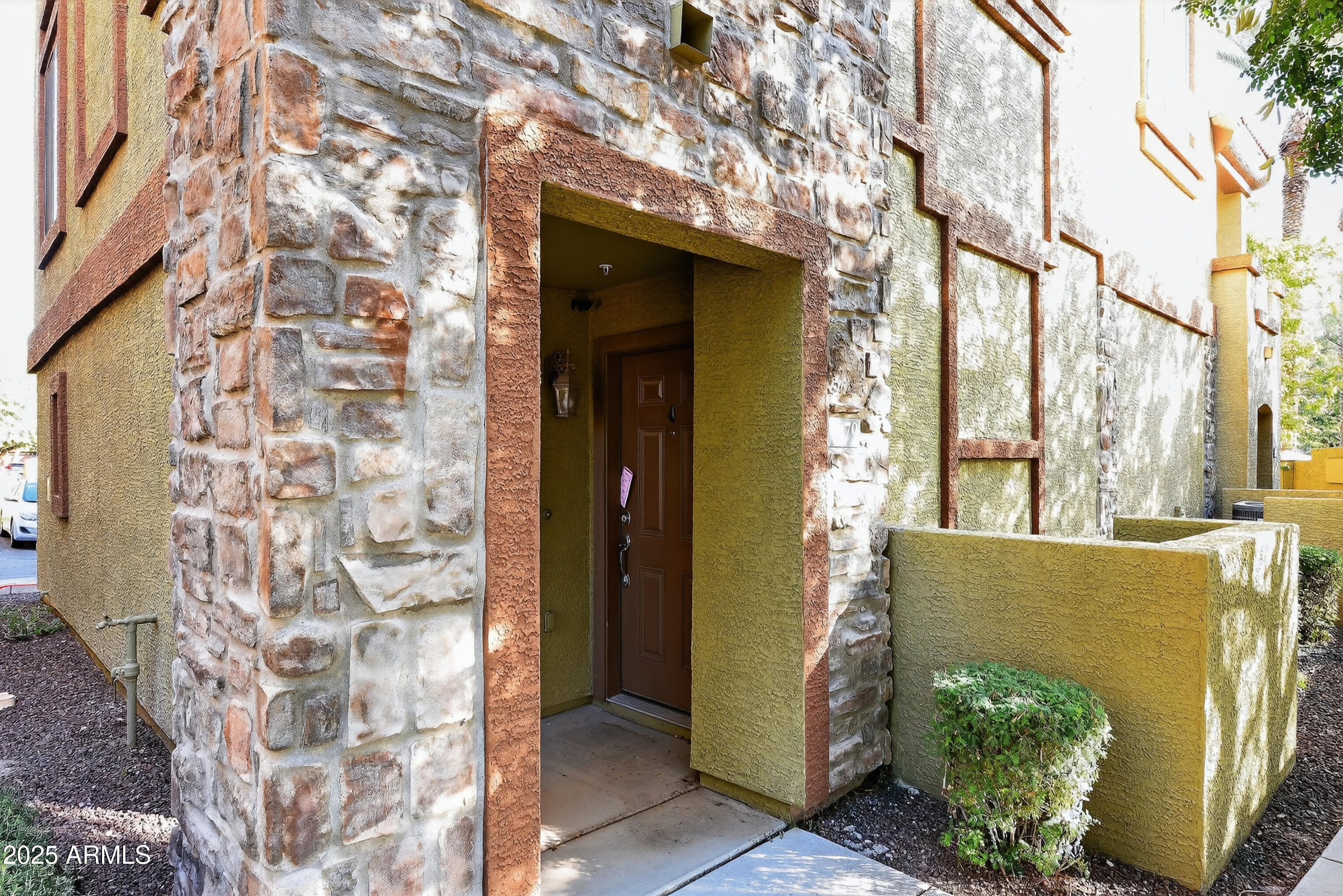 1920 East Bell Road, Unit 1079 Phoenix, AZ 85022 - Photo 5 of 29 a view of a potted plants in front of a brick house