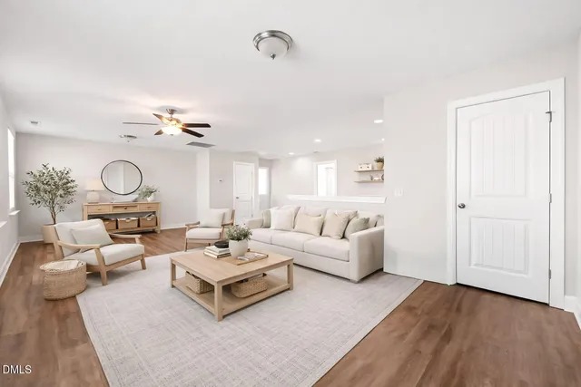 a living room with furniture large window and a table