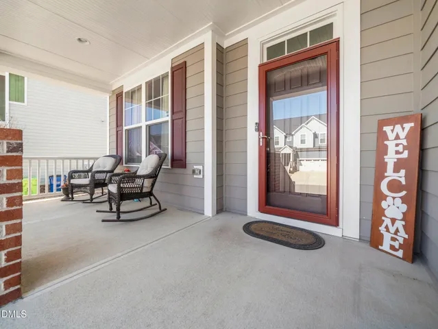 a living room with furniture and large windows