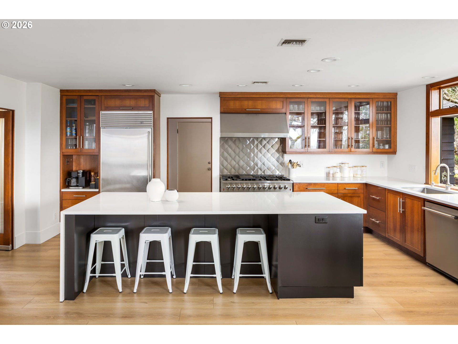 400 Northwest Miller Road Portland, OR 97229 - Photo 13 of 48 a kitchen with stainless steel appliances kitchen island a table chairs in it and wooden floor