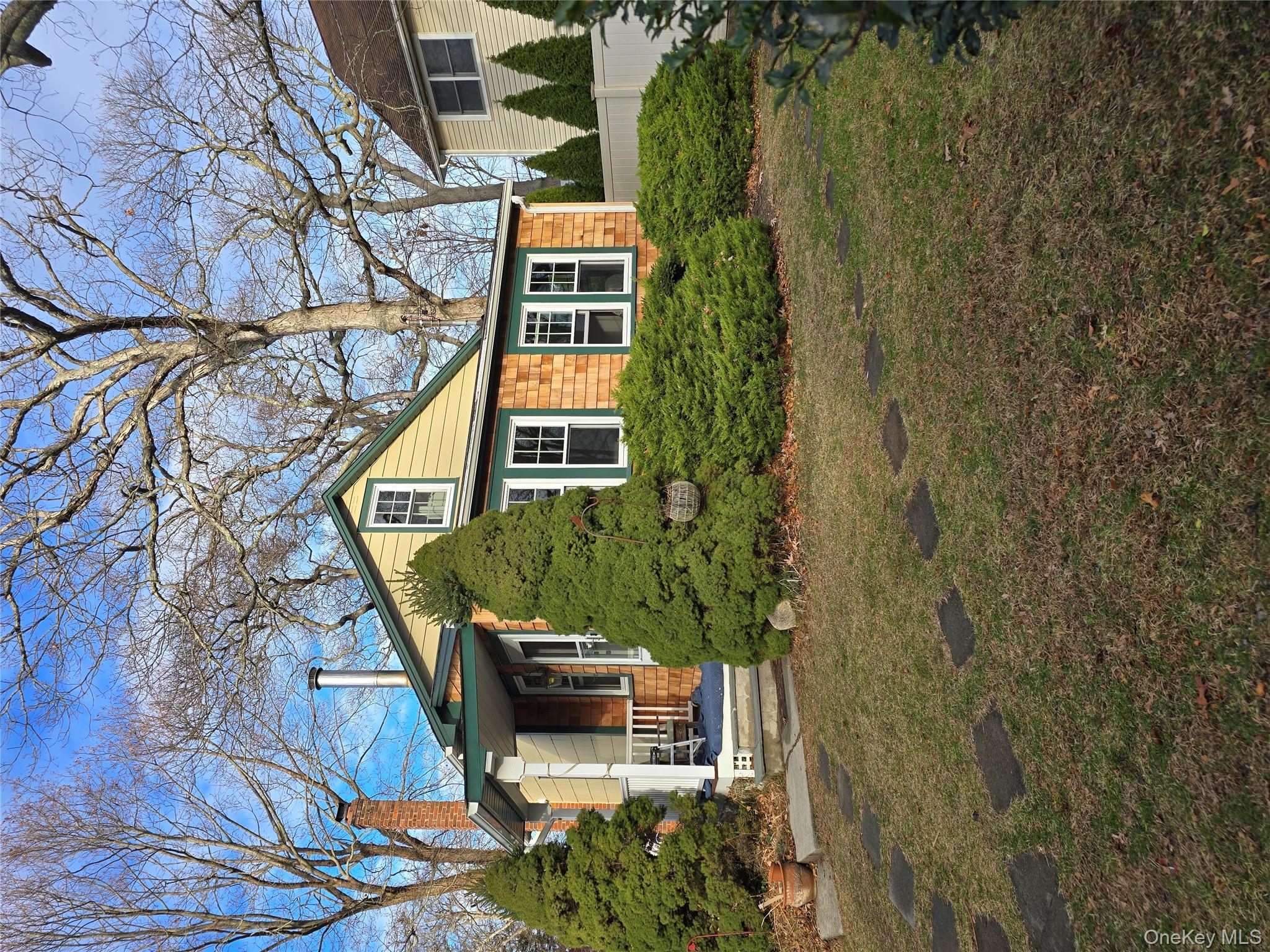 84 Cedar Road Wading River, NY 11792 - Photo 15 of 17 View of front of property with a chimney and covered porch