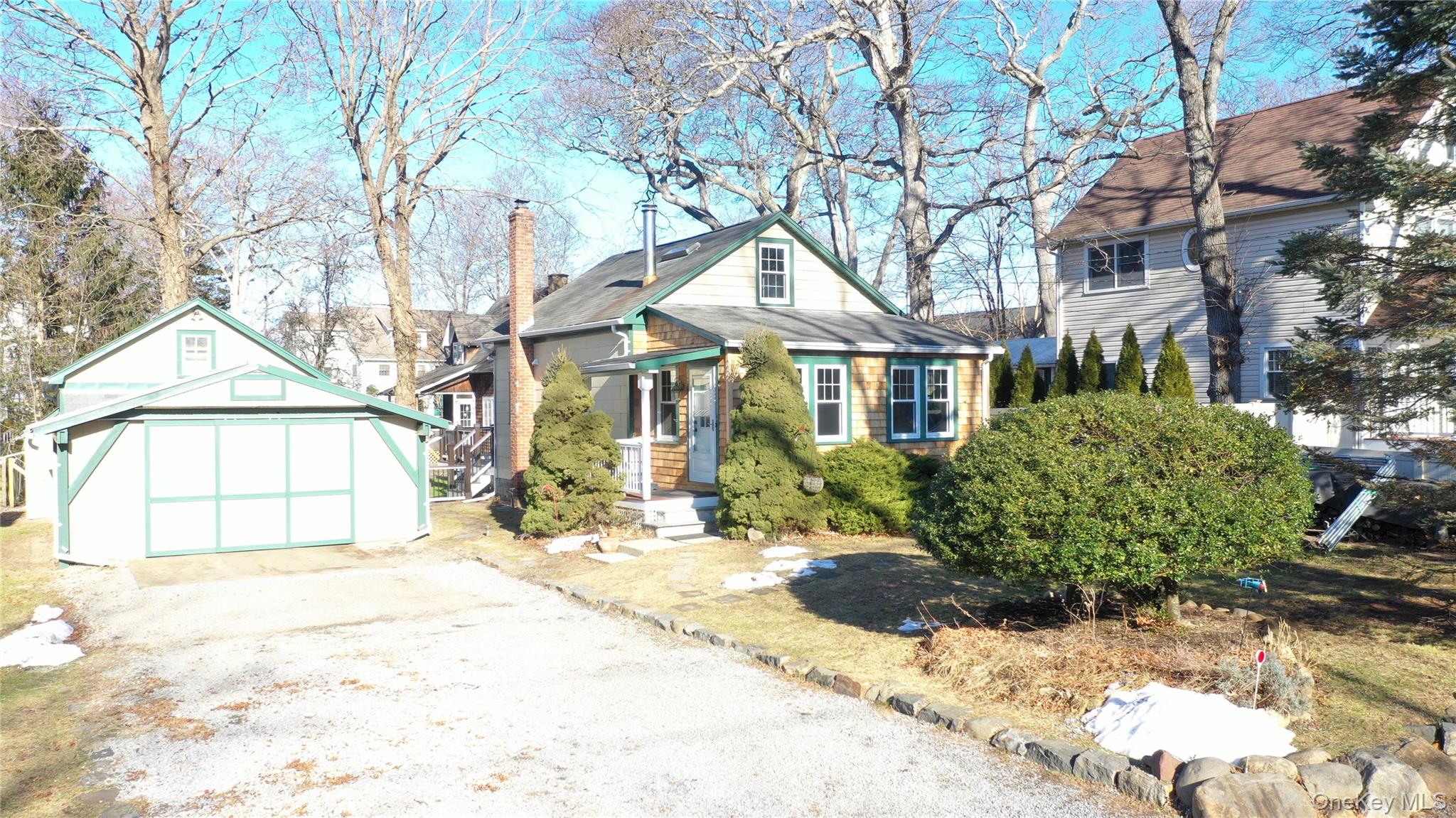 84 Cedar Road Wading River, NY 11792 - Photo 2 of 17 Bungalow with an outdoor structure, a chimney, driveway, and a detached garage