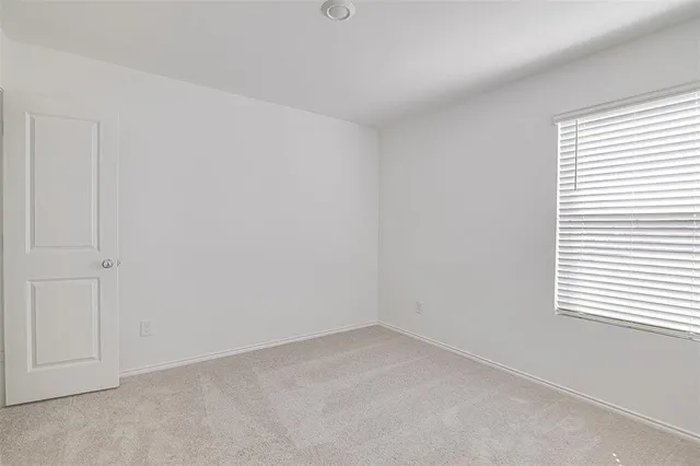 a view of an empty room and a window