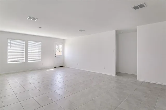 a view of an empty room with windows