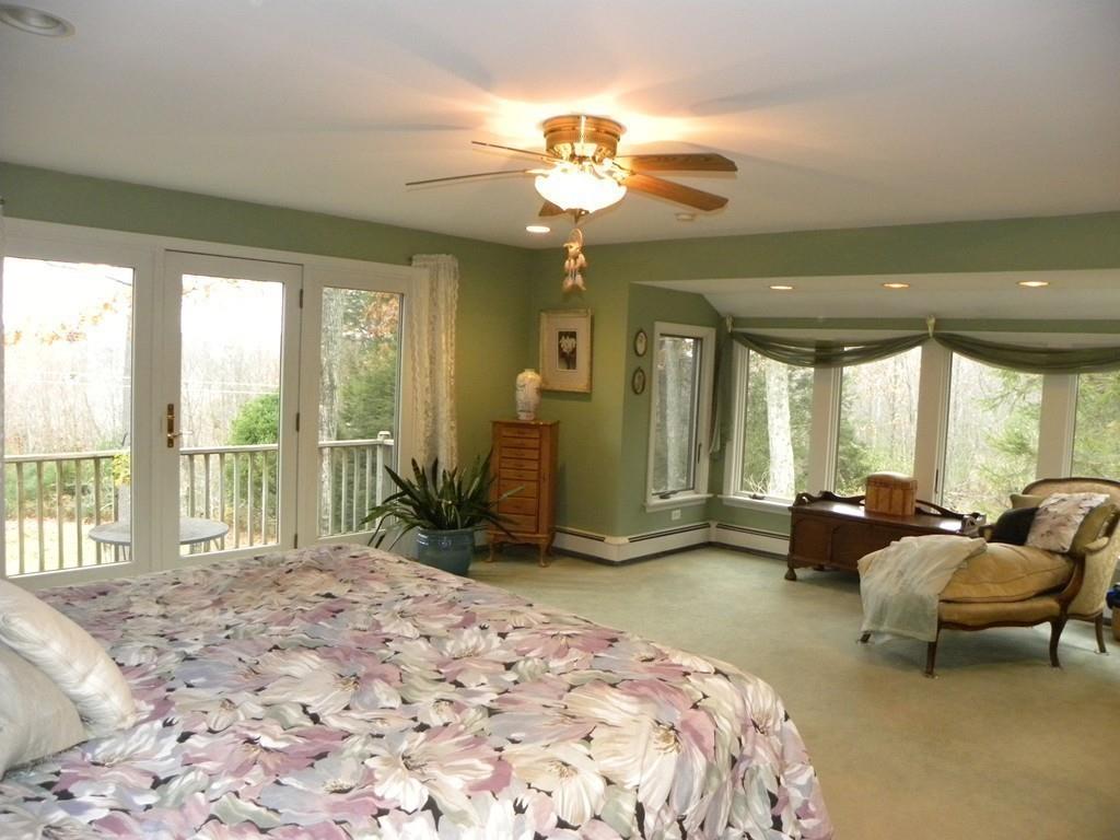 101 Vinton Road Holland, MA 01521 - Photo 21 of 42 a spacious bedroom with a large bed and a chandelier
