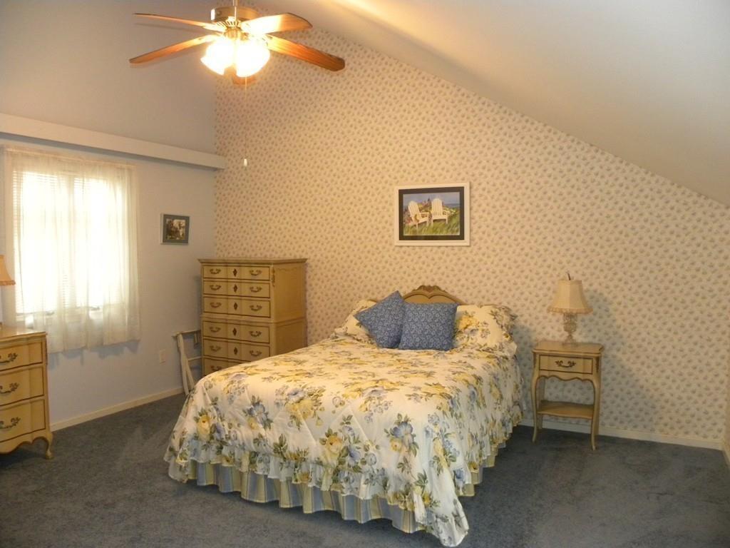 101 Vinton Road Holland, MA 01521 - Photo 22 of 42 a bedroom with a bed and a chandelier