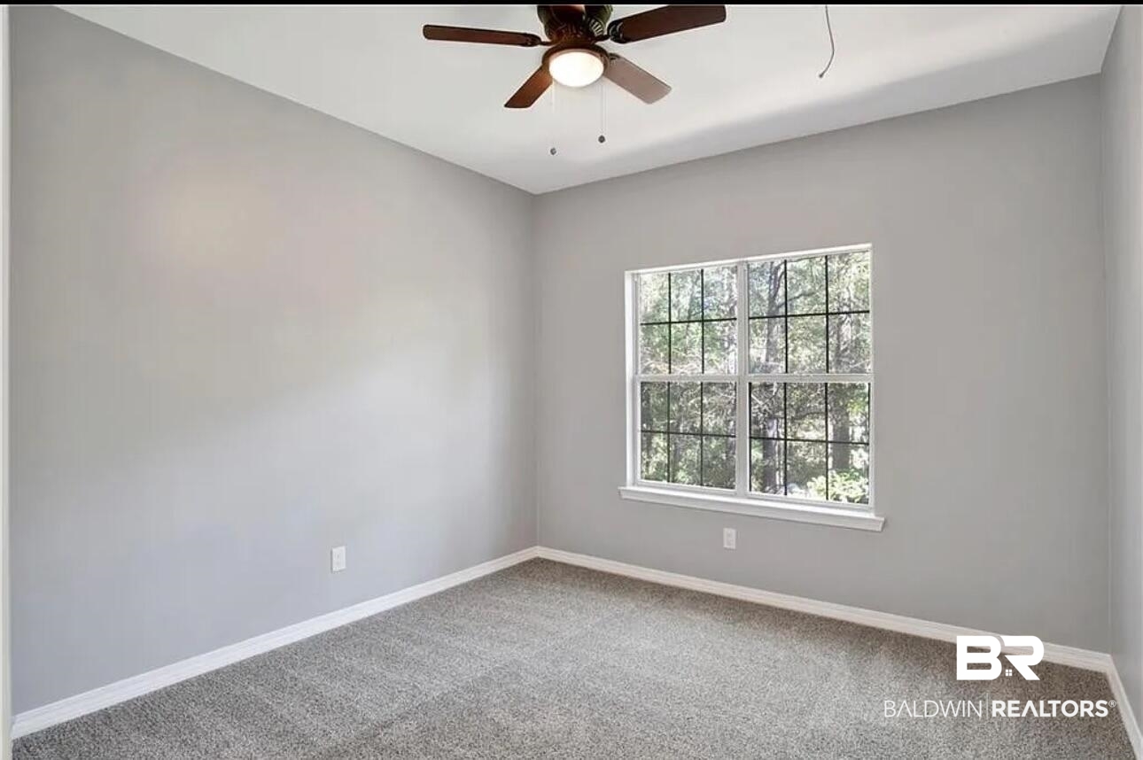 632 Ridgewood Drive Daphne, AL 36526 - Photo 25 of 36 Carpeted empty room with ceiling fan