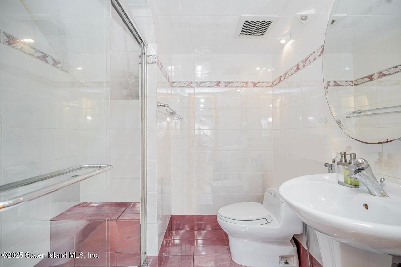 111 Hampton Green Staten Island, NY 10312 - Photo 13 of 19 a bathroom with a sink a toilet and shower