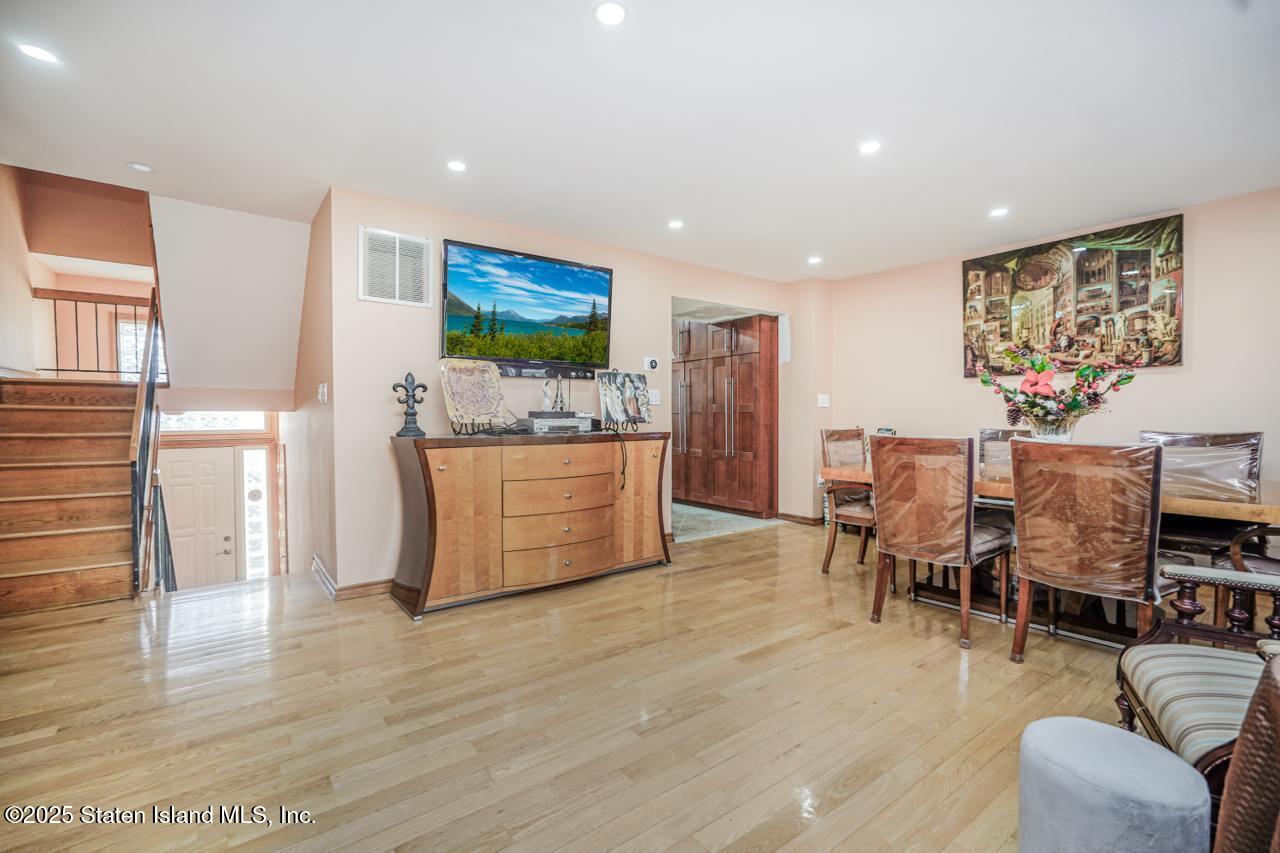 111 Hampton Green Staten Island, NY 10312 - Photo 3 of 19 a living room with furniture and a flat screen tv