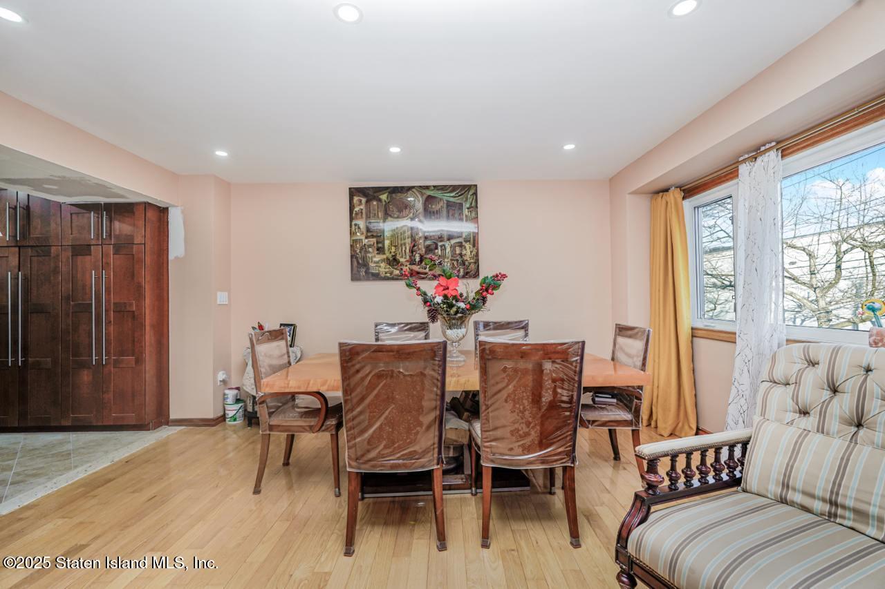 111 Hampton Green Staten Island, NY 10312 - Photo 4 of 19 a dining room with furniture and wooden floor