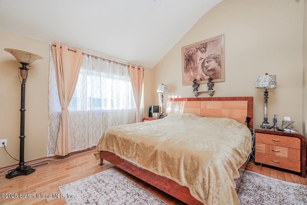111 Hampton Green Staten Island, NY 10312 - Photo 7 of 19 a bedroom with a bed and a window