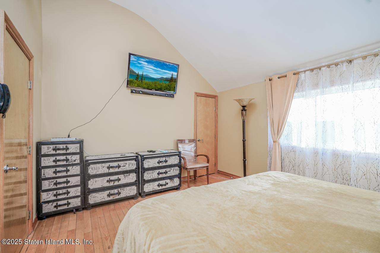 111 Hampton Green Staten Island, NY 10312 - Photo 9 of 19 a bedroom with a bed and a window