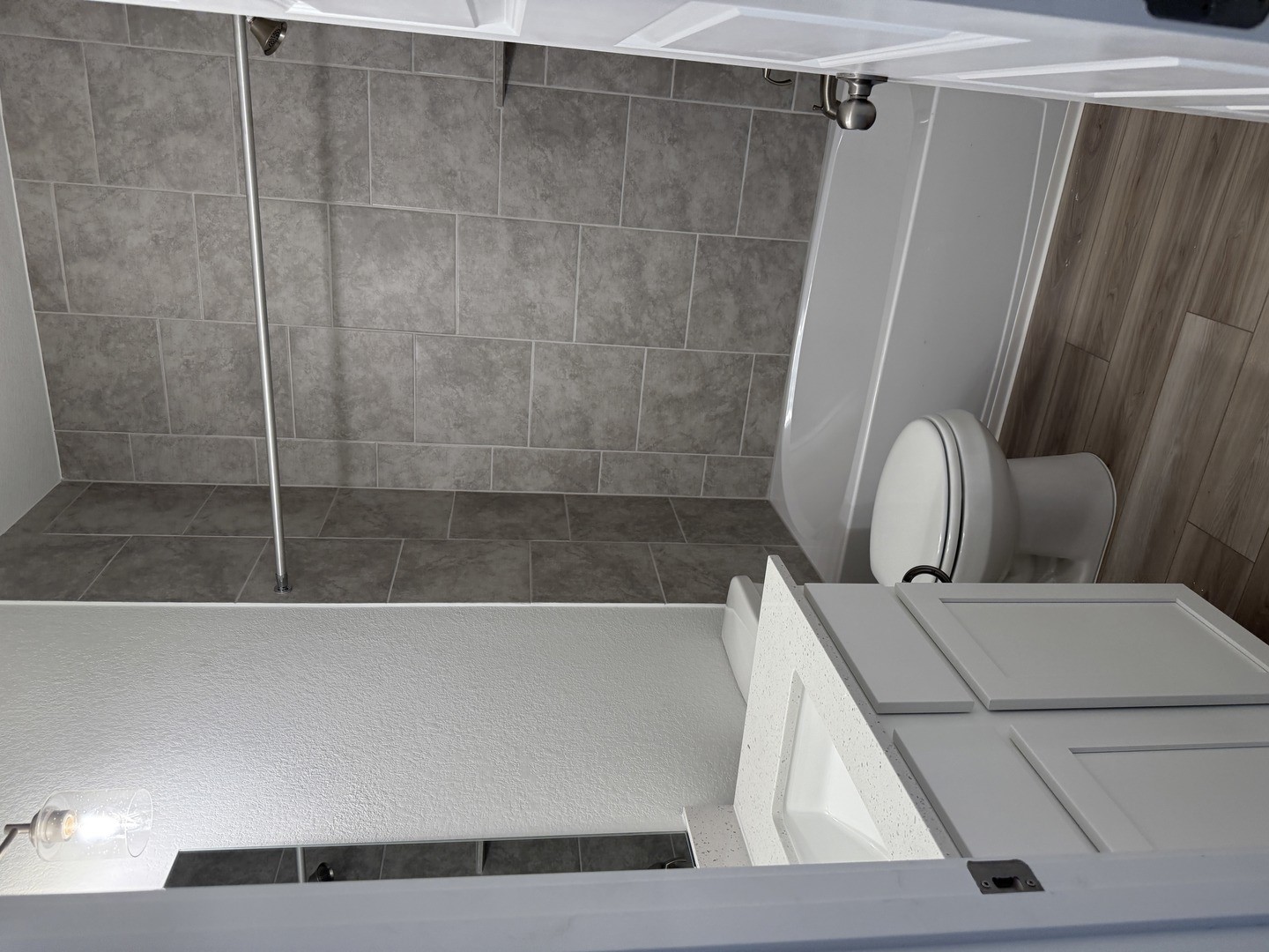 2546 Jack Nora Way Round Rock, TX 78665 - Photo 6 of 8 Bathroom with vanity, a textured wall, dark wood-style floors, and shower / tub combination