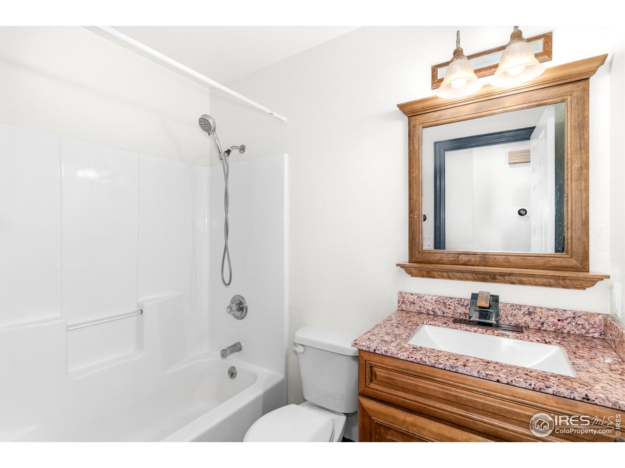 3418 Windmill Court Evans, CO 80620 - Photo 12 of 31 a bathroom with a bathtub and a sink