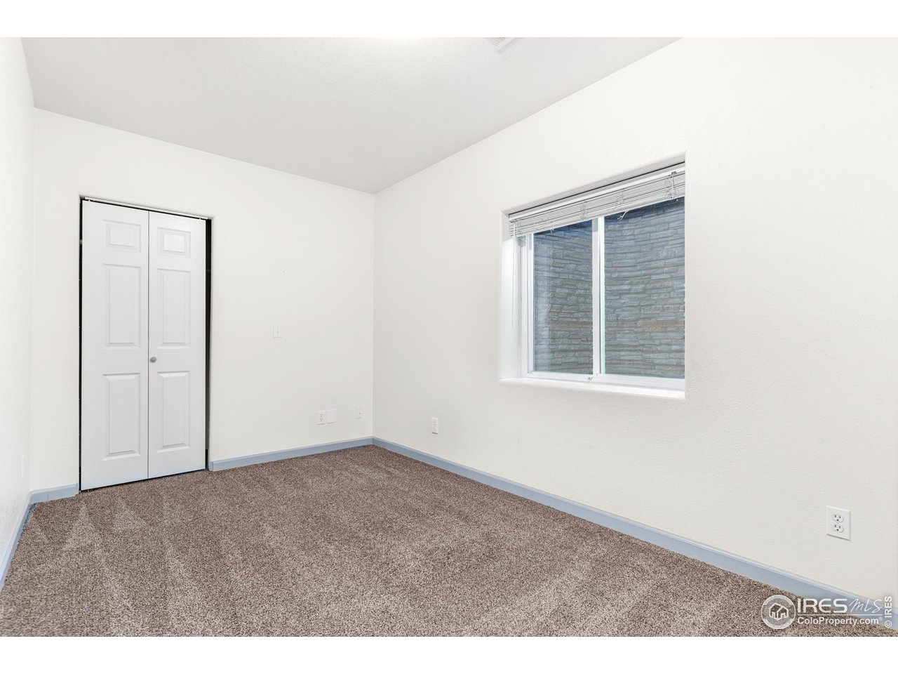 3418 Windmill Court Evans, CO 80620 - Photo 18 of 31 an empty room with windows