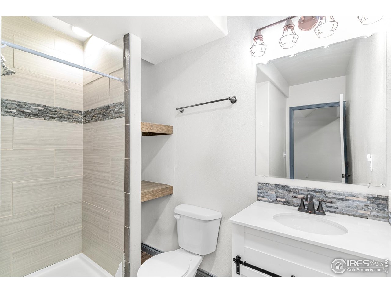 3418 Windmill Court Evans, CO 80620 - Photo 19 of 31 a bathroom with a sink a toilet and shower