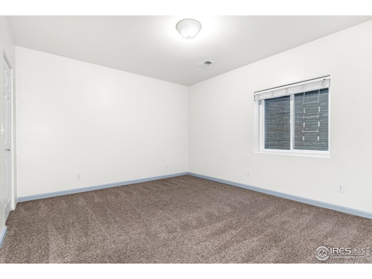 3418 Windmill Court Evans, CO 80620 - Photo 20 of 31 an empty room with windows