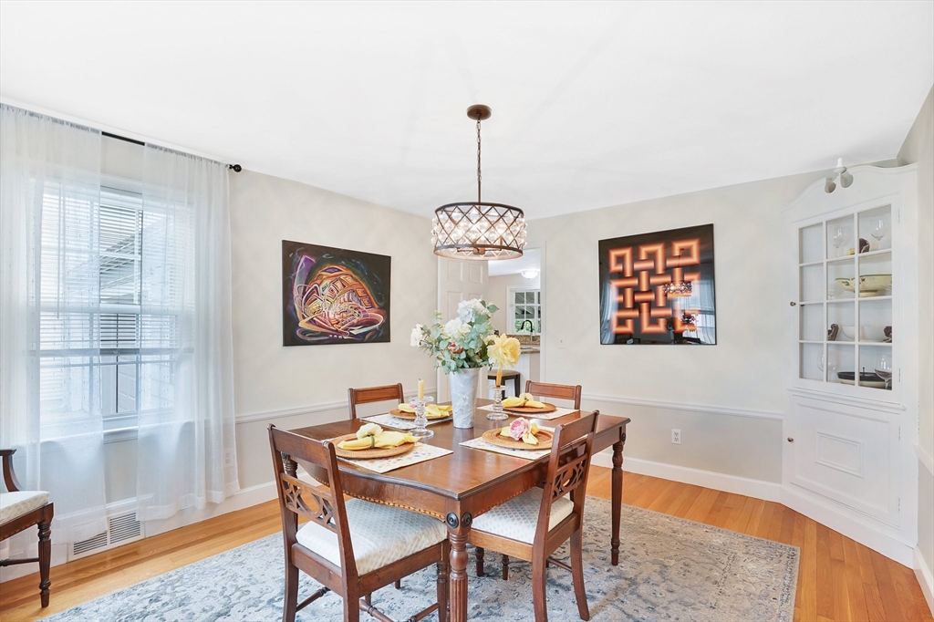 38 Fallston Street Springfield, MA 01119 - Photo 16 of 35 a dining room with furniture a rug and a chandelier