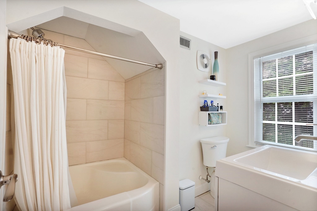 38 Fallston Street Springfield, MA 01119 - Photo 21 of 35 a bathroom with a bathtub and a window