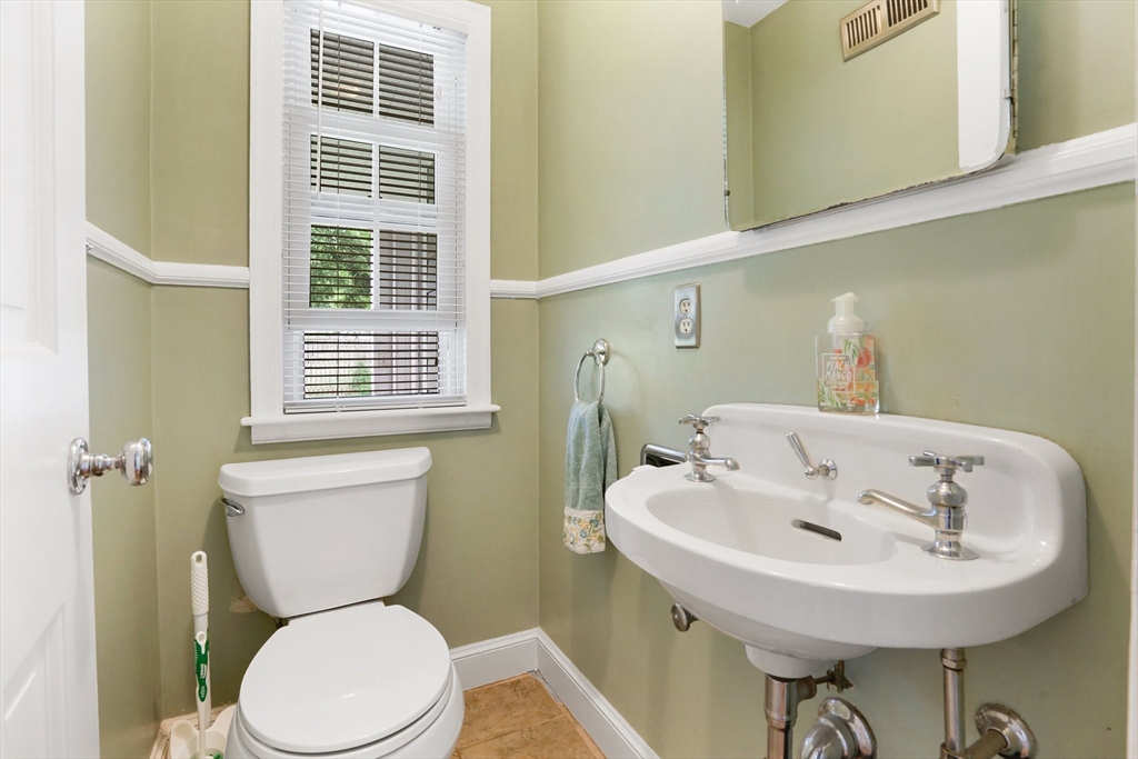 38 Fallston Street Springfield, MA 01119 - Photo 9 of 35 a bathroom with a sink a toilet and a mirror