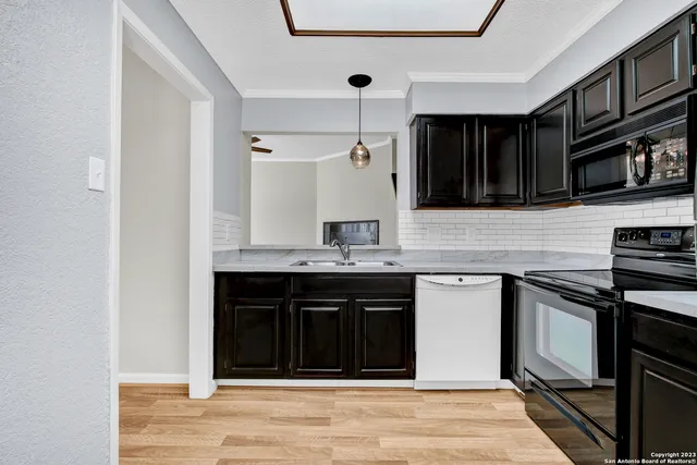 a kitchen with stainless steel appliances granite countertop a stove and a sink