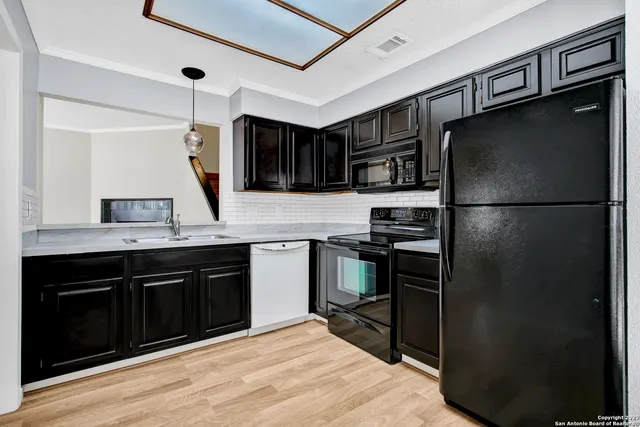 a kitchen with a refrigerator and a sink