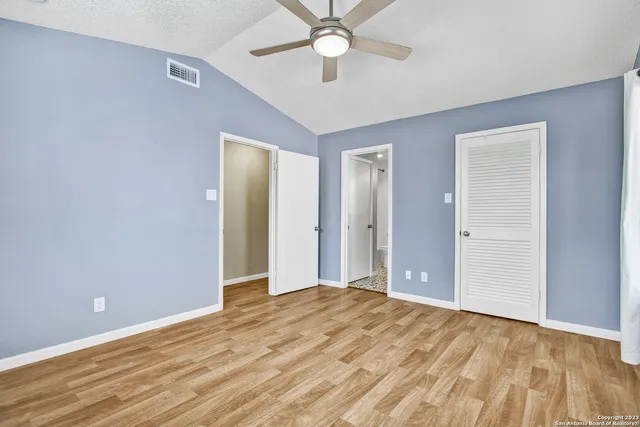 a view of a room with a ceiling fan