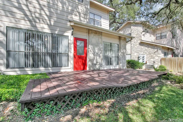 a view of a house with backyard and sitting area