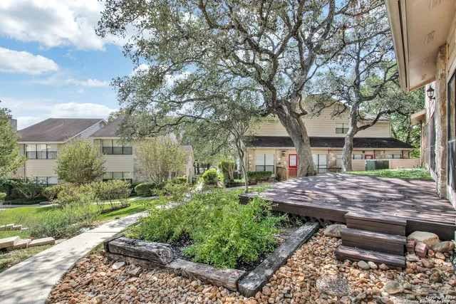 a view of a house with backyard and sitting area