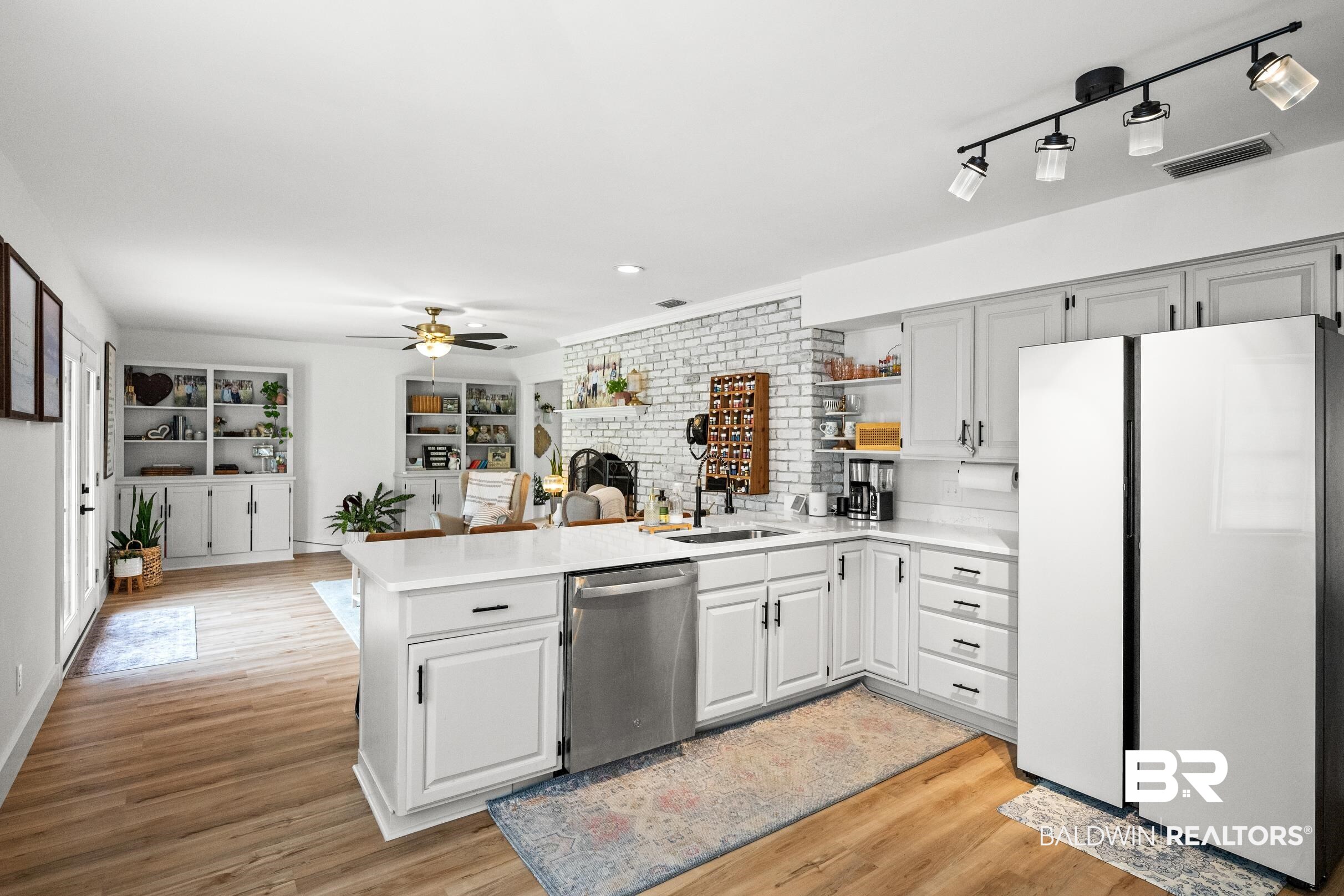 6 Wren Circle Foley, AL 36535 - Photo 21 of 55 Kitchen with visible vents, a sink, stainless steel dishwasher, freestanding refrigerator, and a peninsula