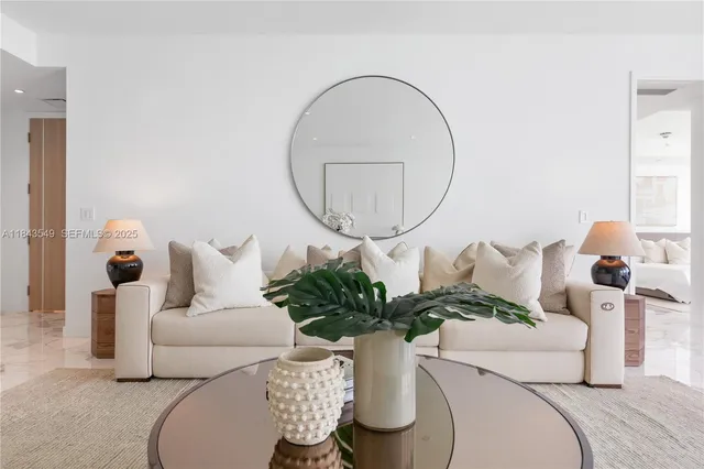 a living room with furniture and a mirror