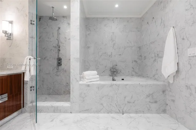 a bathroom with a bathtub and a shower