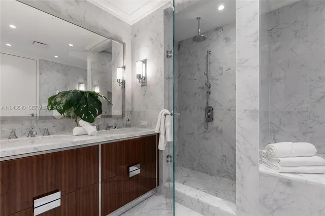 a bathroom with a double vanity sink toilet and shower