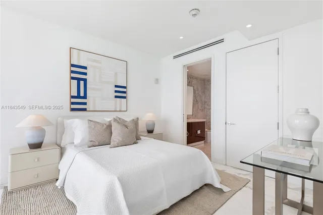 a bedroom with a bed and a lamp