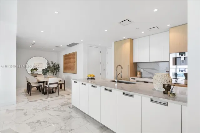 a kitchen with stainless steel appliances granite countertop a sink and cabinets