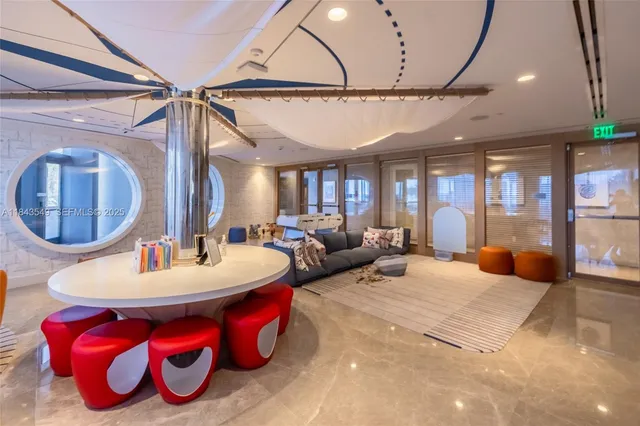 a living room with lots of furniture and a chandelier