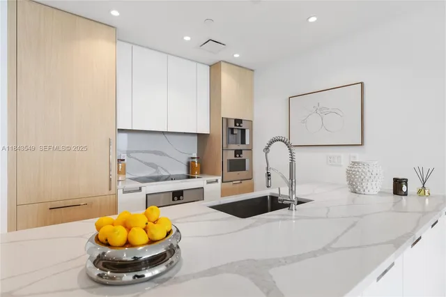 a view of a kitchen with a sink and chandelier
