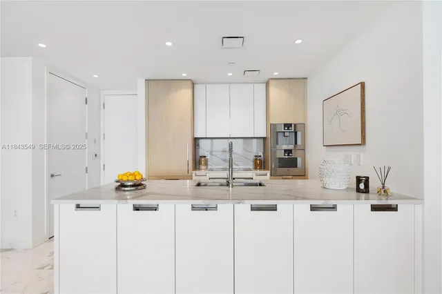 a kitchen with a sink cabinets and appliances
