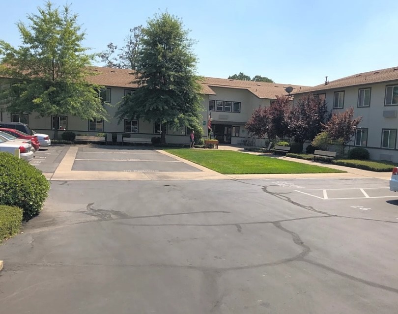 910 Canby Road Redding, CA 96003 - Photo 2 of 6 a view of house with a yard and a car parked in front of it