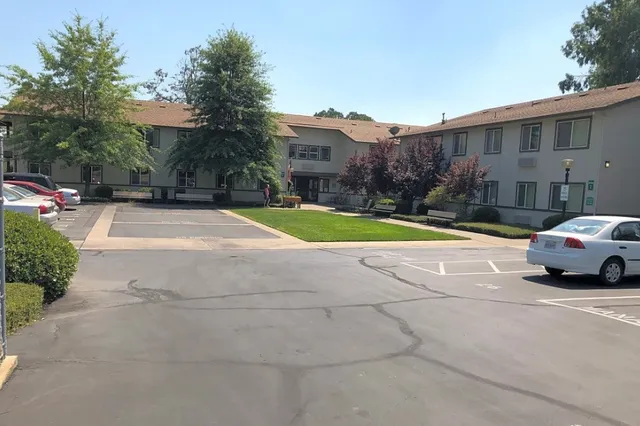 a view of pool with a yard